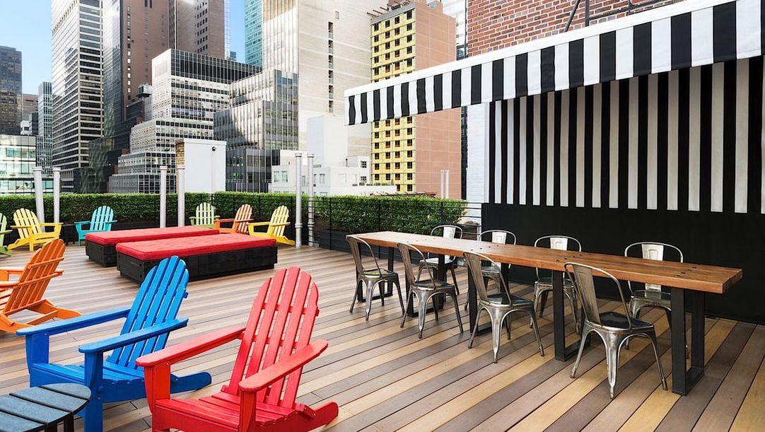 Picture: The rooftop lounge at Pod 51 features colorful seating and dining table. There is no food or beverage service, but guests are welcome to bring their own food and beverage.